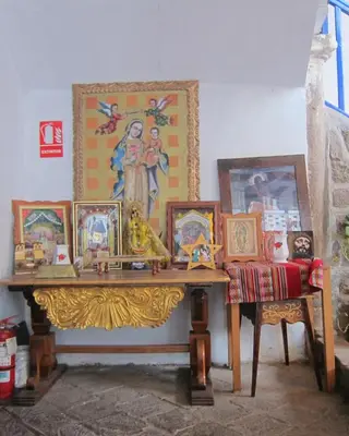 a room with a table with pictures on it at Garden Inn 488 in Cusco