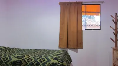 a bedroom with a bed and a window at Garden Inn 488 in Cusco