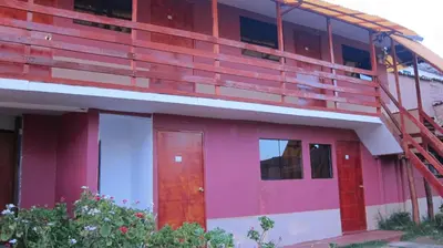 a red and white building with a ladder on it at Garden Inn 488 in Cusco