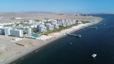 an aerial view of a beach with buildings and the water at 1 Fila Vista Bahía Paracas - La Velas 501 T1 in Paracas