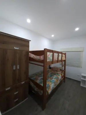 a bedroom with two bunk beds and a dresser at Tranquilidad y Sol in Cieneguilla