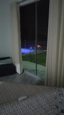 a bedroom with a large window with a view of a street at Tranquilidad y Sol in Cieneguilla