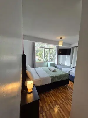 a bedroom with two beds and a window at Casa Yanahuara Valle Sagrado - Urubamba in Urubamba