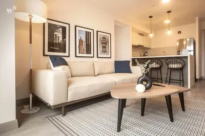 a living room with a couch and a table at Alta by Wynwood House in Lima