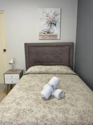 a bed with a roll of toilet paper on it at Casa Las Flores Ica in Ica