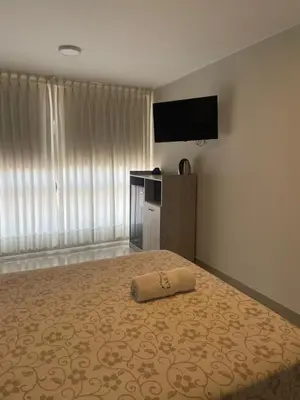 a bedroom with a bed with a pillow on it at Casa Las Flores Ica in Ica