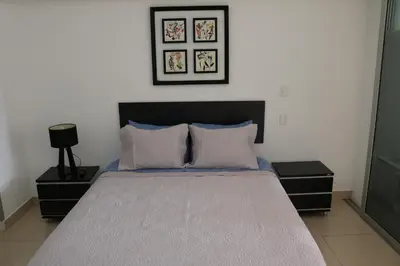 a bedroom with a large bed with two night stands at Terrazas Apartments Miraflores in Lima