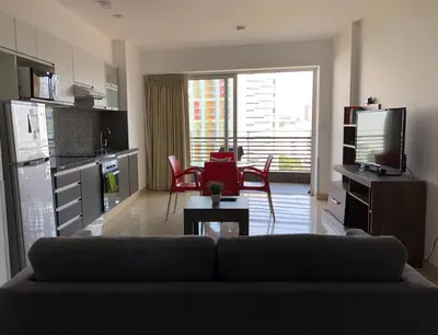 a living room with a couch and a kitchen at Terrazas Apartments Miraflores in Lima