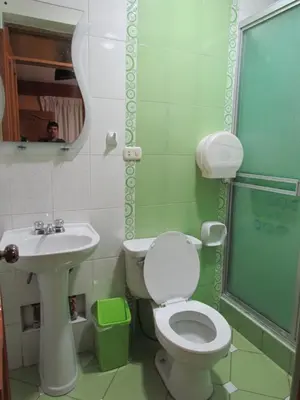 a bathroom with a toilet and a sink and a mirror at Hotel Colquewasi in Cusco
