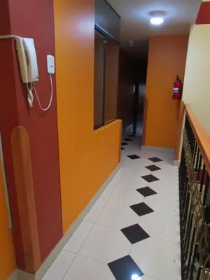 a hallway with a phone on the wall and ailed floor at Hotel Colquewasi in Cusco