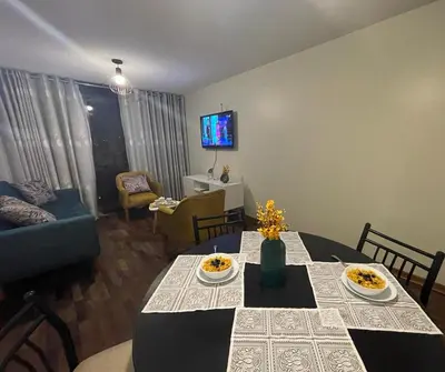 a living room with a dining room table with plates of food at Departamento completo Surquillo/Miraflores in Lima