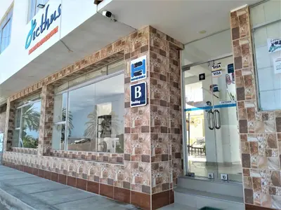 a building with a b sign on the side of it at Icthus Paracas in Paracas
