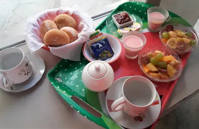 a table with a tray of breakfast foods and cups at Icthus Paracas in Paracas