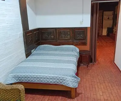 a bed sitting in a room with at La Quinta Alcanfores in Lima