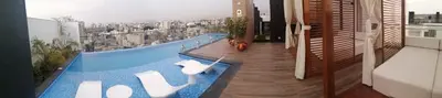 a swimming pool with a view of a city at Apartamento acogedor en Barranco - cerca a Miraflores in Lima