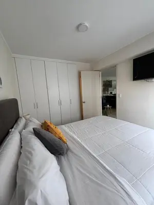 a bedroom with a large white bed with pillows at Apartamento acogedor en Barranco - cerca a Miraflores in Lima