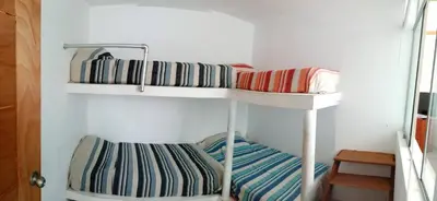 two bunk beds in a corner of a room at Departamentos Cerro Azul P1 in Cerro Azul