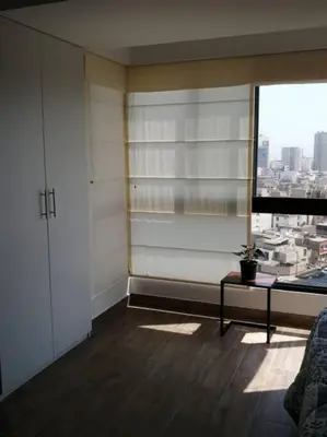 a room with a window with a view of a city at MODERNO LOFT BARRANCO, VISTA PANORAMICA in Lima