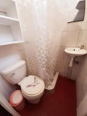 a small bathroom with a toilet and a sink at Maypa Lima Airport in Lima
