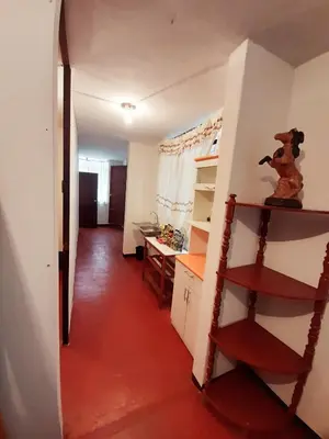 a hallway of a room with a kitchen and a desk at Maypa Lima Airport in Lima