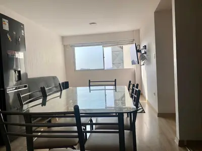 a dining room with a glass table and chairs at Céntrico mini departamento, moderno y acogedor in Lima