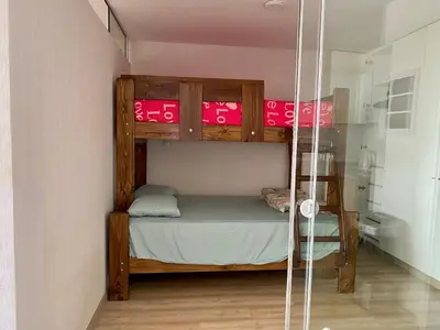 a bunk bed in a small room with a shower at Céntrico mini departamento, moderno y acogedor in Lima