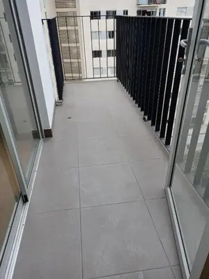 a walkway in a building with glass doors at VERSALLES APARTMENT in Lima