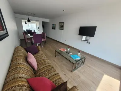 a living room with a couch and a table at Espacio Luxury Apartments - Malecón 28 de Julio. in Lima