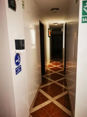 a hallway with a sign on a wall and ailed floor at Los Sauces in Huacho