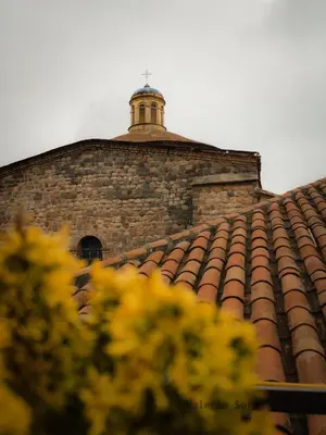 a brick building with a tower on top of a roof at Hotel Santa Maria in Cusco