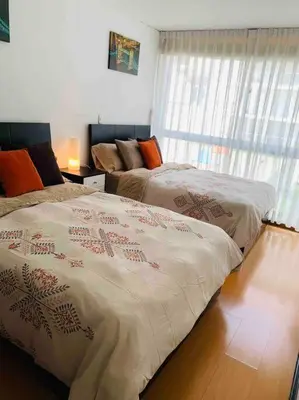 a bedroom with two beds and a window at Lovely two bedroom apartment in Miraflores in Lima