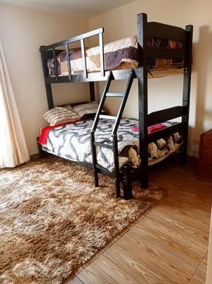 a bedroom with a bunk bed and a rug at Dpto entero, 2do piso, ascensor y cochera in Lima