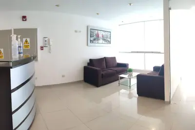 a living room with two couches and a table at Dpto entero, 2do piso, ascensor y cochera in Lima