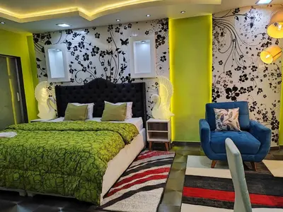 a bedroom with a bed and a blue chair at Casalos Hotel & Spa in Huancayo
