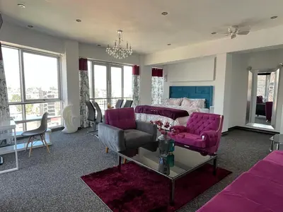 a living room with purple furniture and a couch at Casalos Hotel & Spa in Huancayo