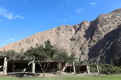 an old building in front of a mountain at Cha'skas Checkta Eco-Lodge in Santa Rosa de Quives