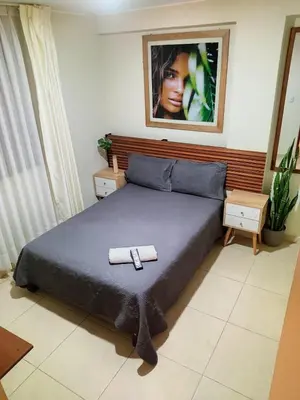 a bedroom with a bed with two towels on it at Hotel Kallma Adventures in Ica