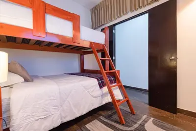 a bedroom with two bunk beds and a ladder at Sweet MATERNITY Home & 3 dormitorios, AIRE ACONDICIONADO in Lima
