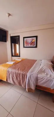 a bedroom with two beds in a room at Illari Wari II-Hotel Sauna in Ayacucho