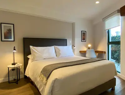 a bedroom with a large white bed and a window at Monumental by Wynwood House in Lima