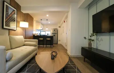 a living room with a couch and a table at Monumental by Wynwood House in Lima