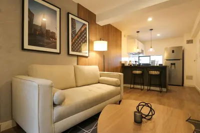 a living room with a couch and a table at Monumental by Wynwood House in Lima