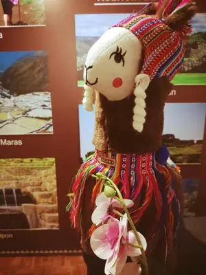 a stuffed doll of a woman in a dress with flowers at ENEDE HOSTEL in Cusco