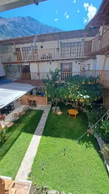 a courtyard with chairs and tables in a building at Luisa in Ollantaytambo
