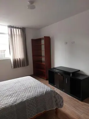 a bedroom with a bed and a dresser and a window at Hospedaje Margarita in La Merced