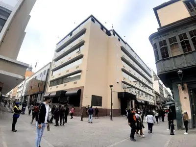 a group of people walking around in a street at Hotel MAURY in Lima