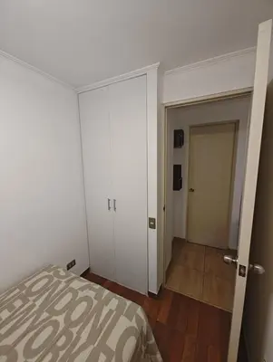 a bedroom with a bed and a door to a hallway at Dpto PARQUE SAN FELIPE in Lima