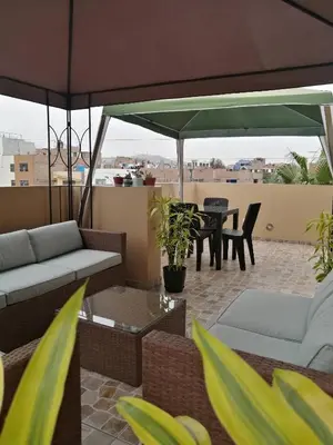 a patio with a table and chairs and an umbrella at Matty House in Lima