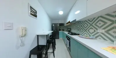 a kitchen with a counter and a phone on the wall at Vistamar Duplex in Lima