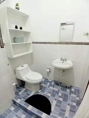a bathroom with a toilet and a sink at Miraflores Kennedy Park in Lima